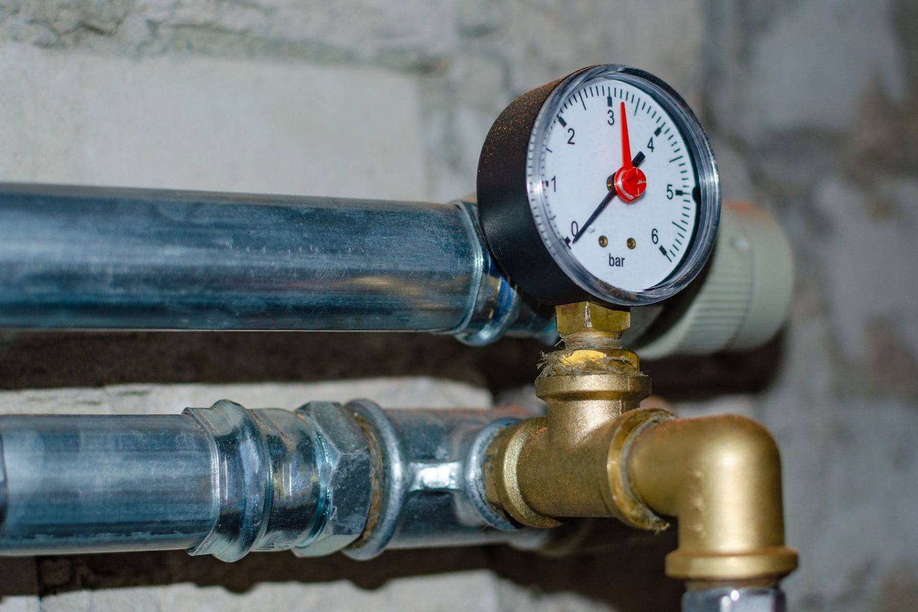 A home water pressure regulator with a pressure gauge attached