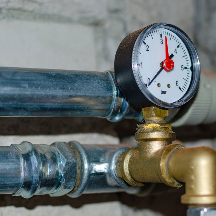A home water pressure regulator with a pressure gauge attached