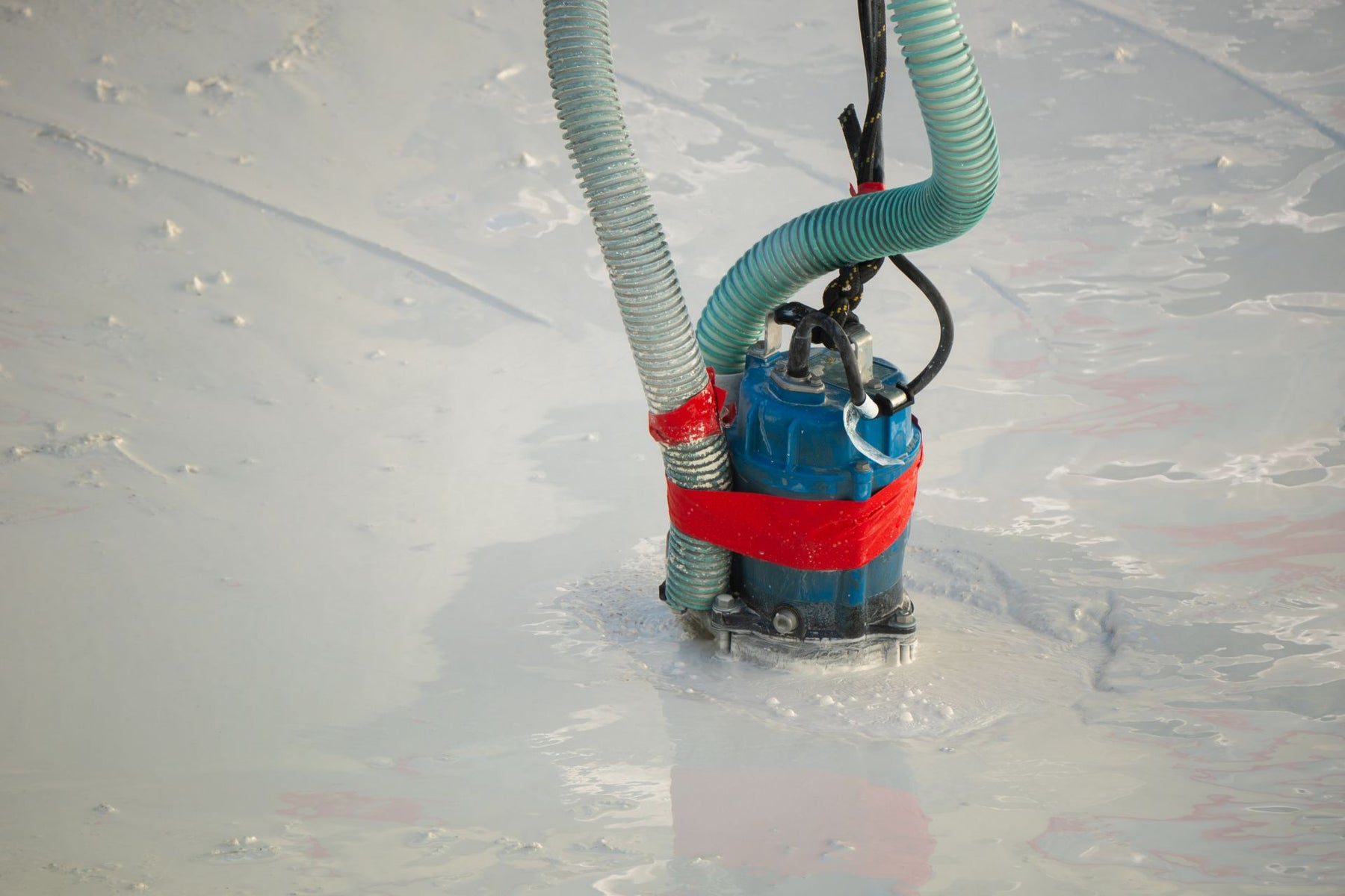 A sump pump working to remove floodwater