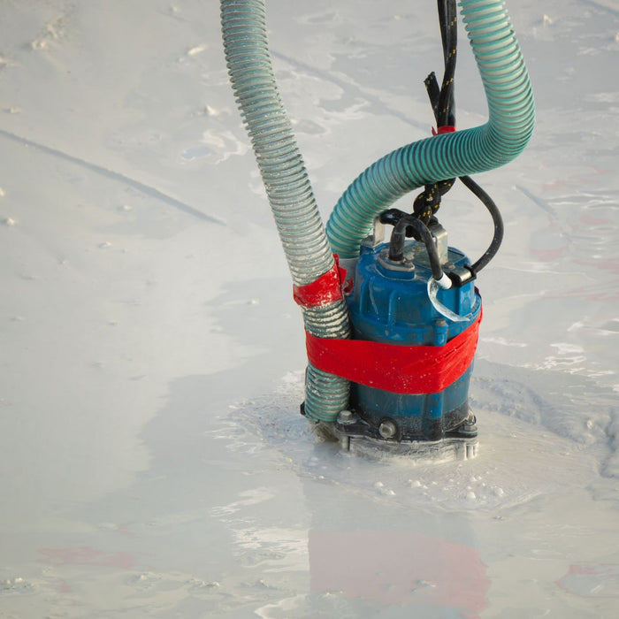 A sump pump working to remove floodwater
