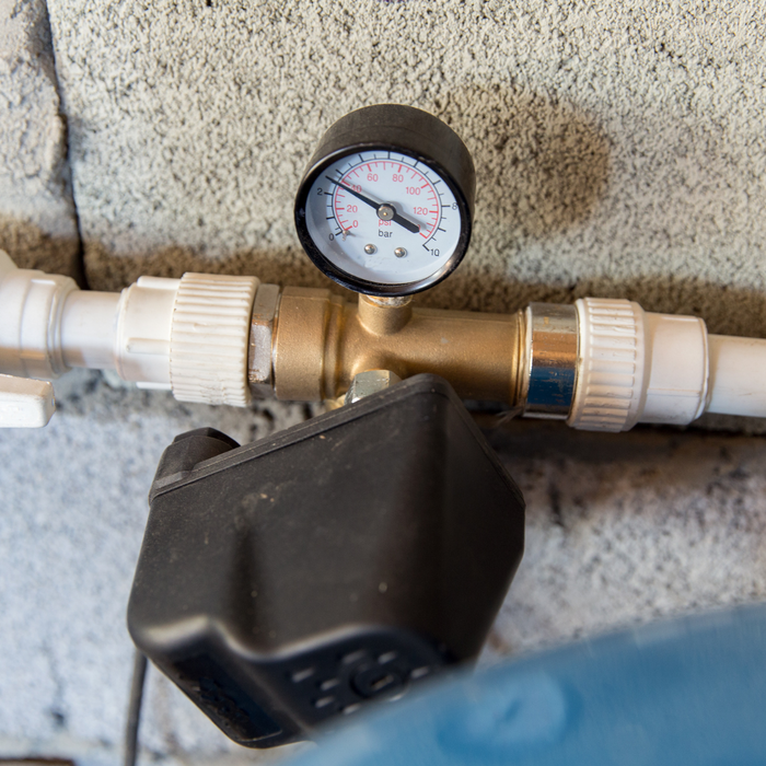 Well pump pressure gauge and plastic pressure switch housing